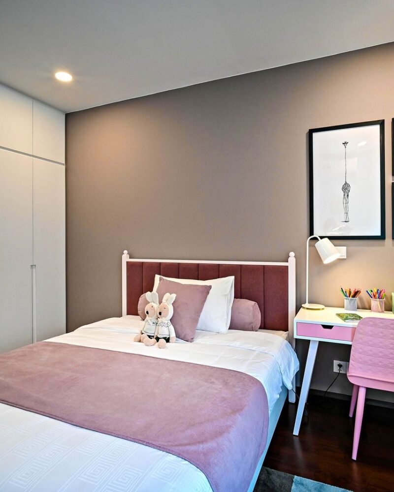 Child bedroom with a low bed, a study desk under the window and open storage at a height a child can reach